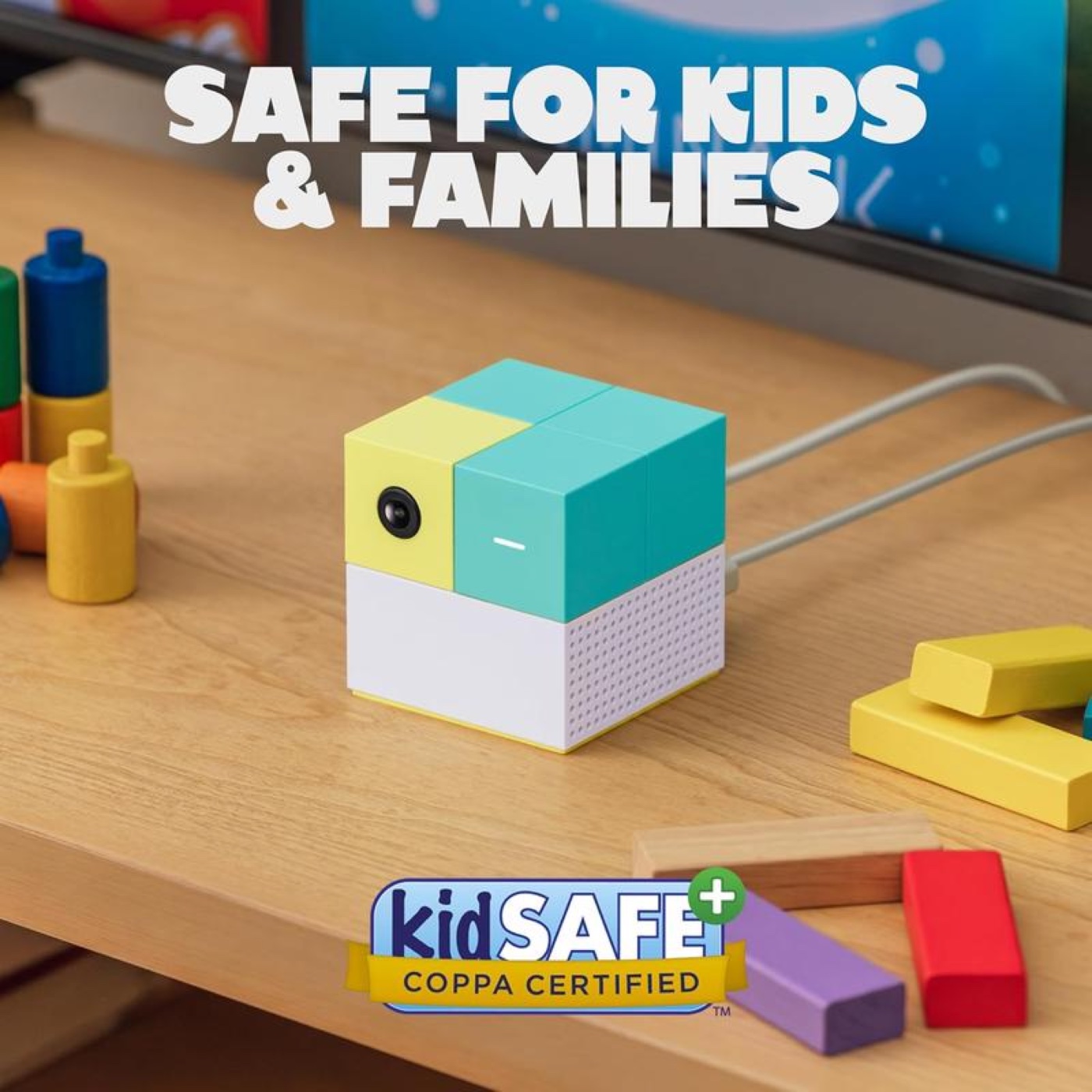 PlayCube on a desk next to wooden toys, kidSAFE certified badge