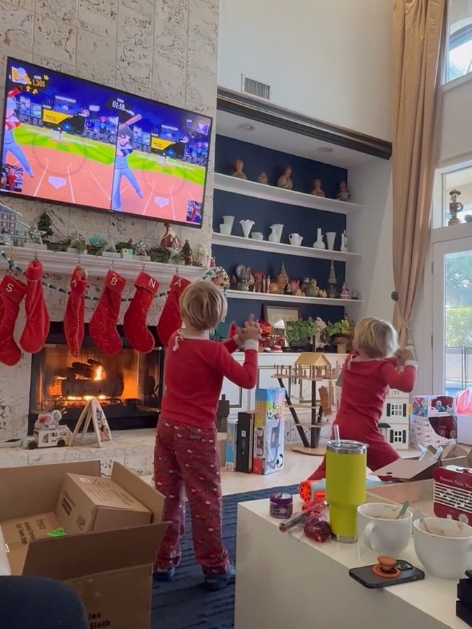 Two children in red pyjamas playing a baseball game on PlayCube